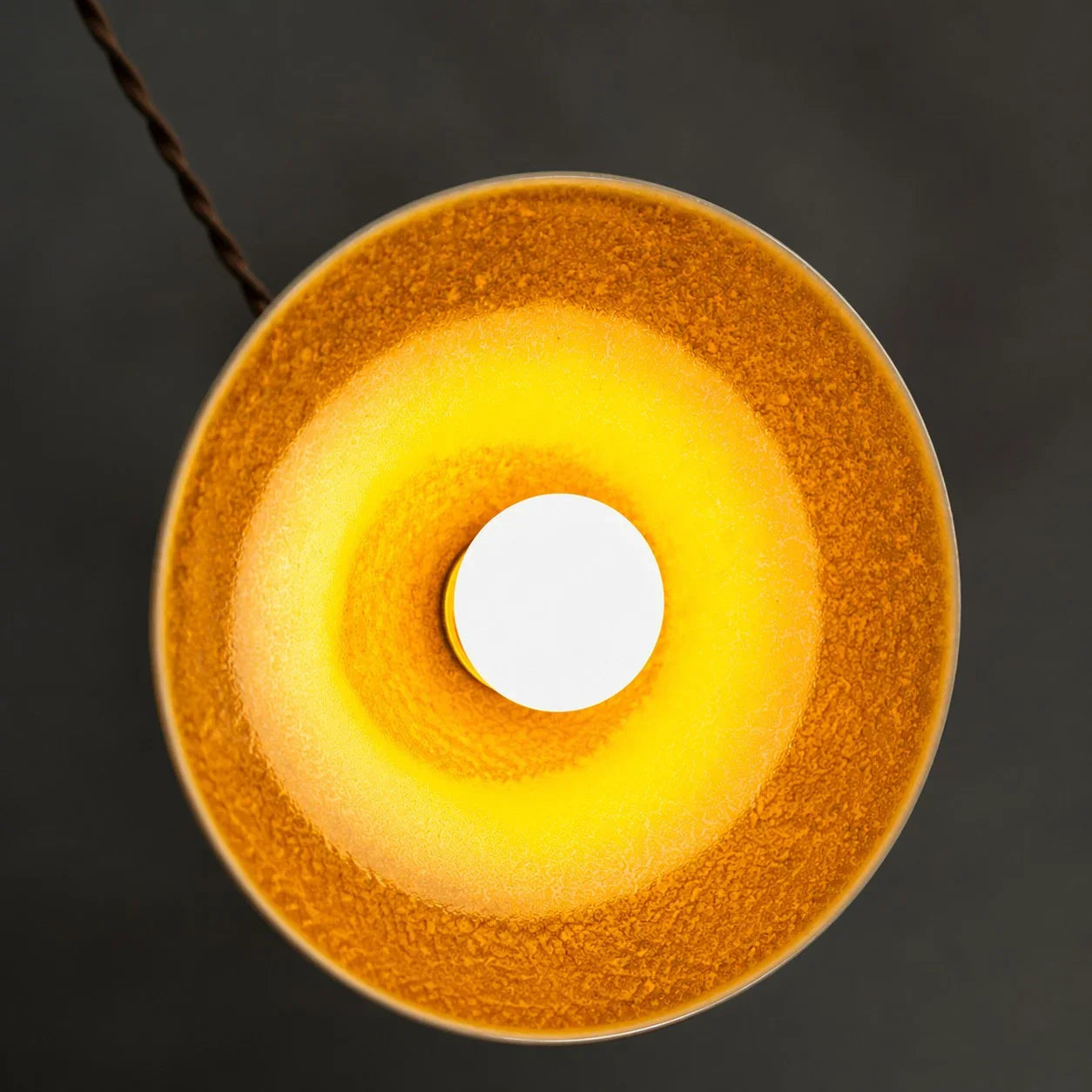 Underside view of the yellow ceramic glaze and open bulb area