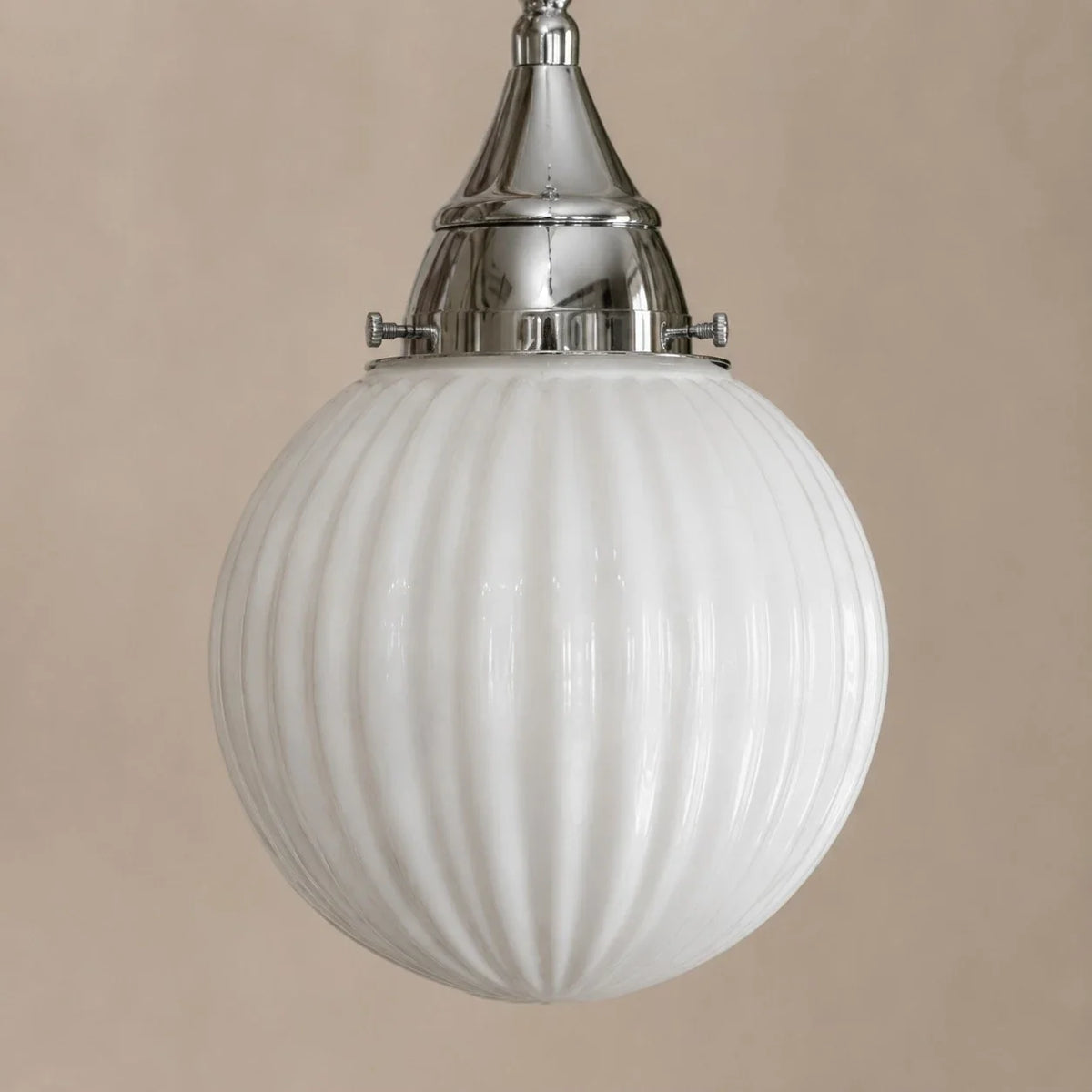 Close view of ribbed glass shade and metal cap