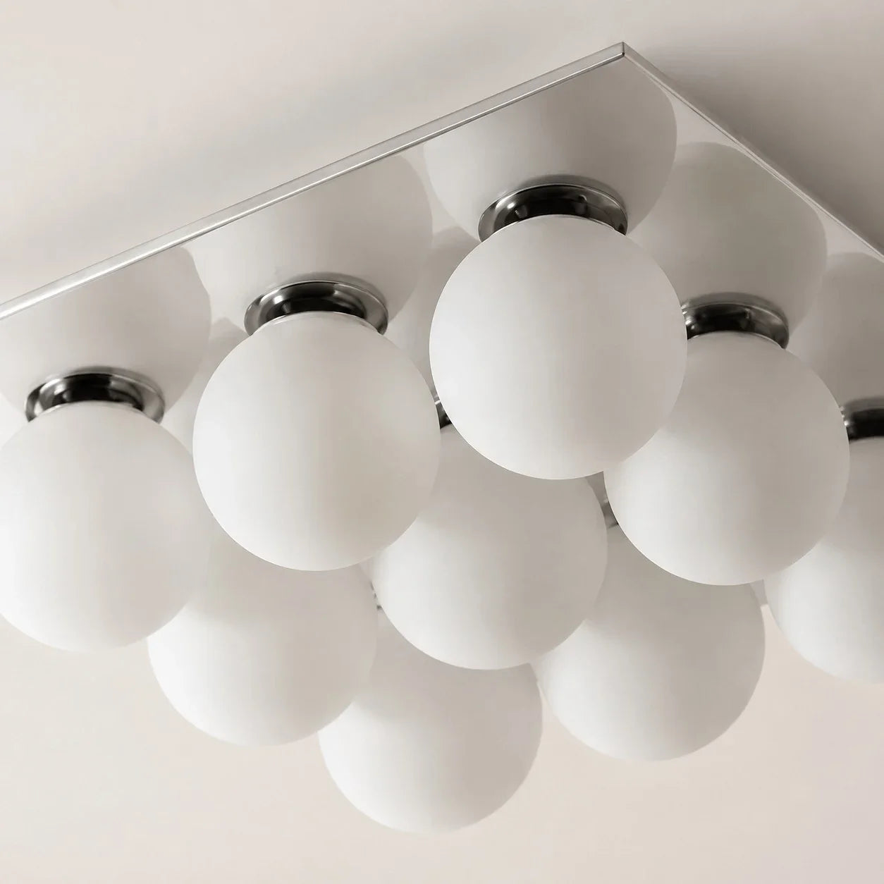Detail image: frosted glass globes and chrome lamp holders.