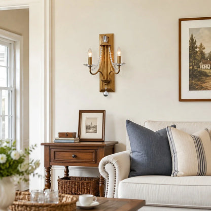 Vintage brass crystal double wall sconce installed beside a sofa
