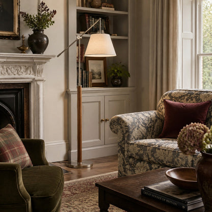 Swing arm fabric floor lamp near a fireplace seating area
