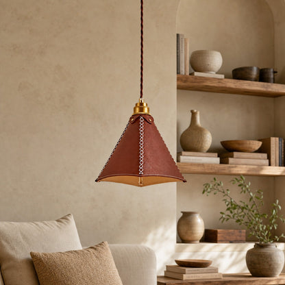 Leather pendant light beside layered shelving in a cozy room