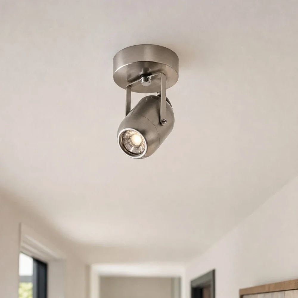 Compact metal wall lamp on a corridor ceiling