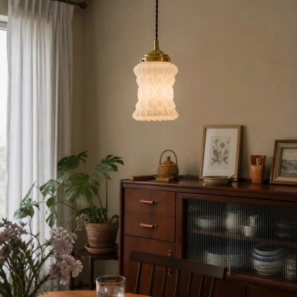 Warm glowing milk glass pendant in dining room