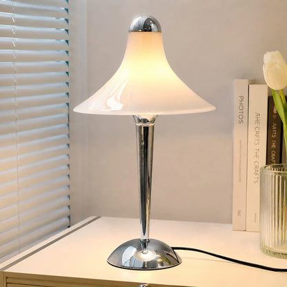 White table lamp on a sideboard with books