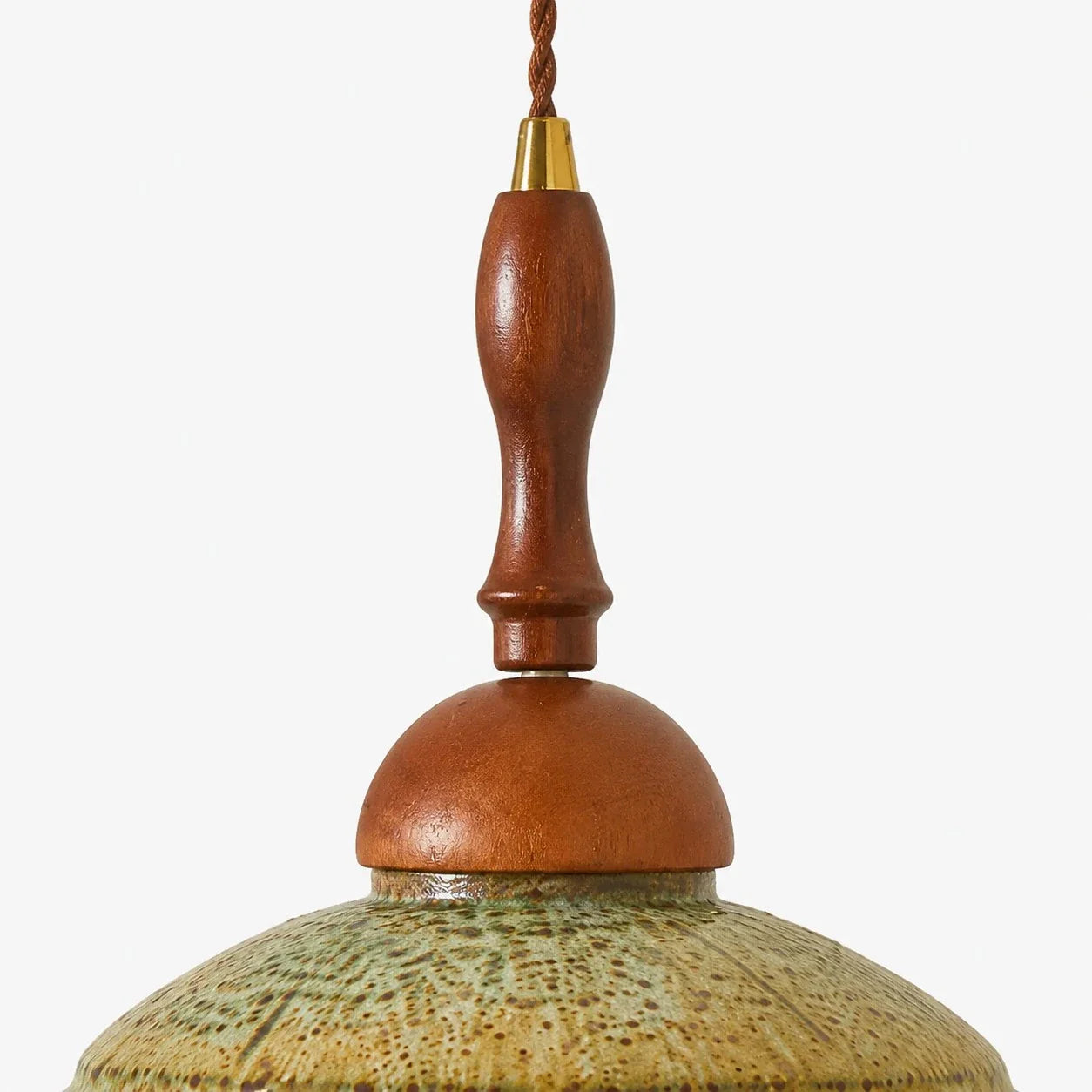 Close view of the warm wood stem, metal collar and textured shallow shade on the wall sconce