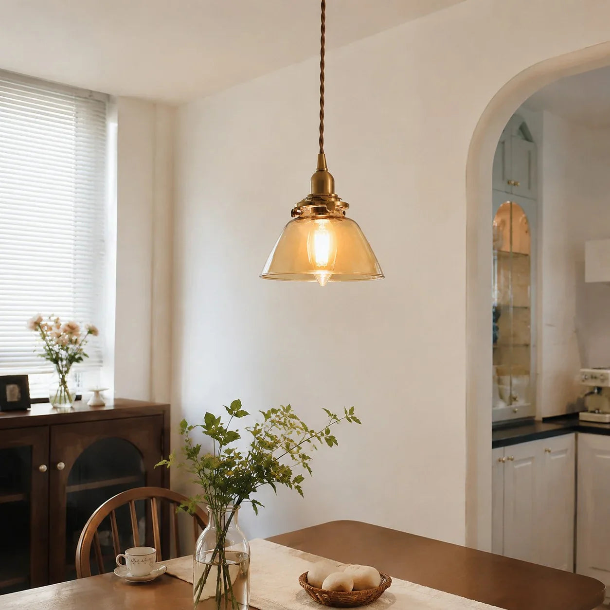 Amber glass pendant in a soft entry scene