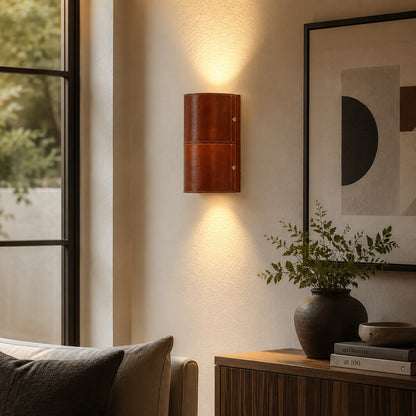 Brown leather wall sconce installed beside a sofa and window