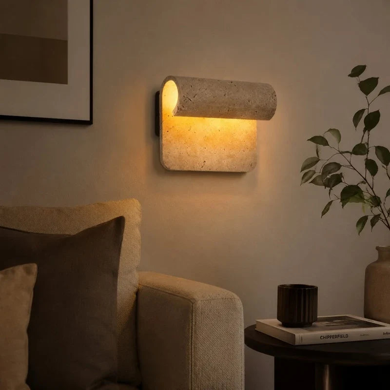 Travertine wall sconce in reading corner