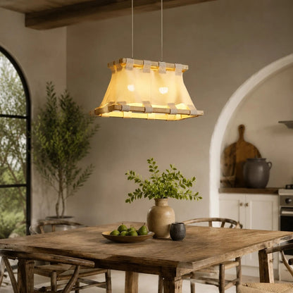 Wabi-sabi fabric pendant lamp above rustic dining table