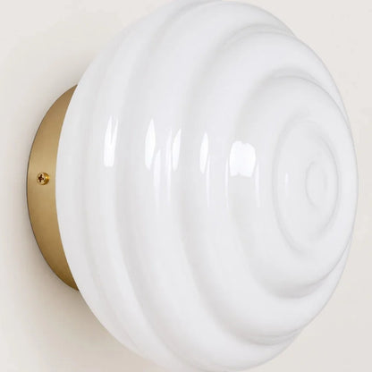 Glossy white ribbed glass shade and round metal wall plate detail