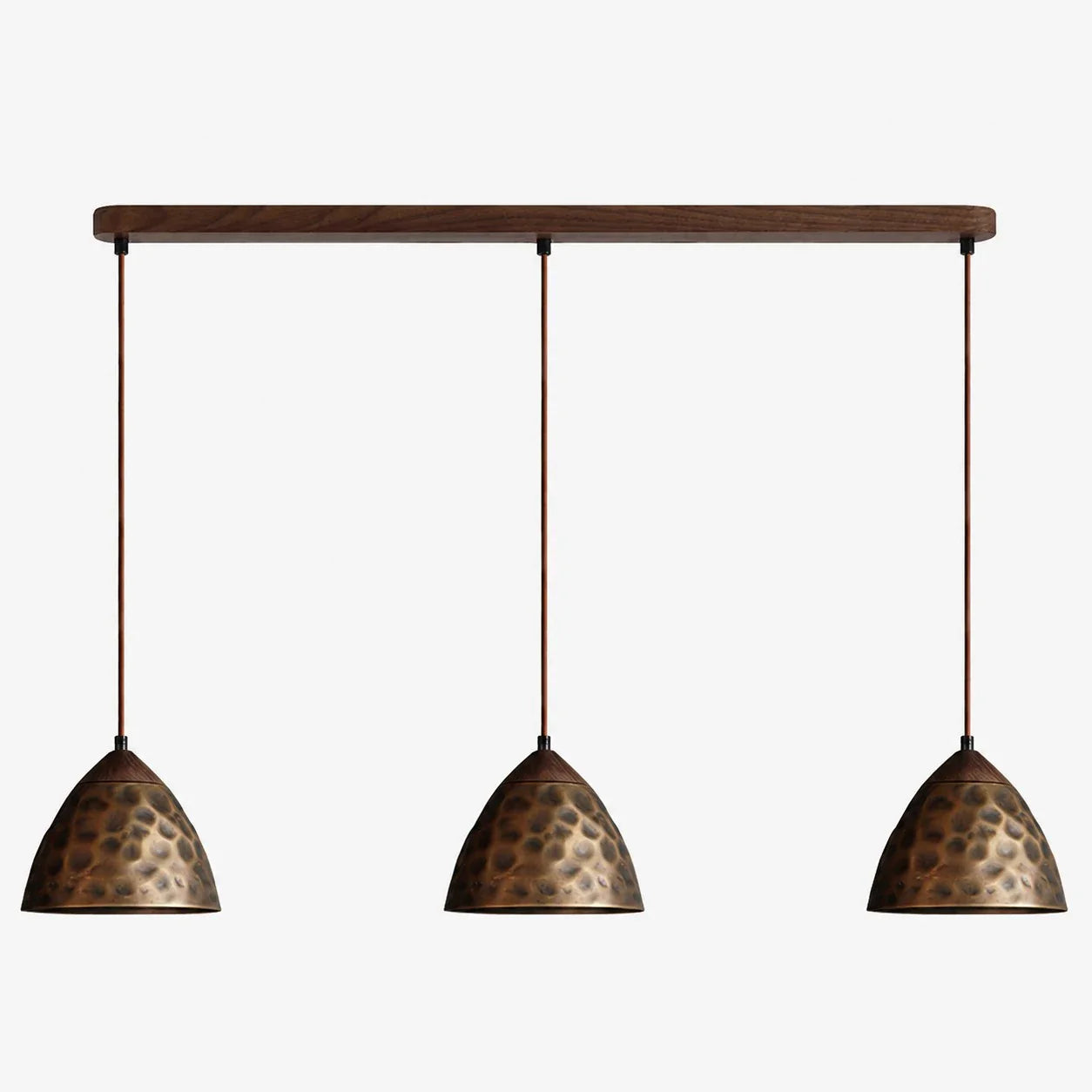 Three-light hammered copper hill pendant on walnut ceiling base