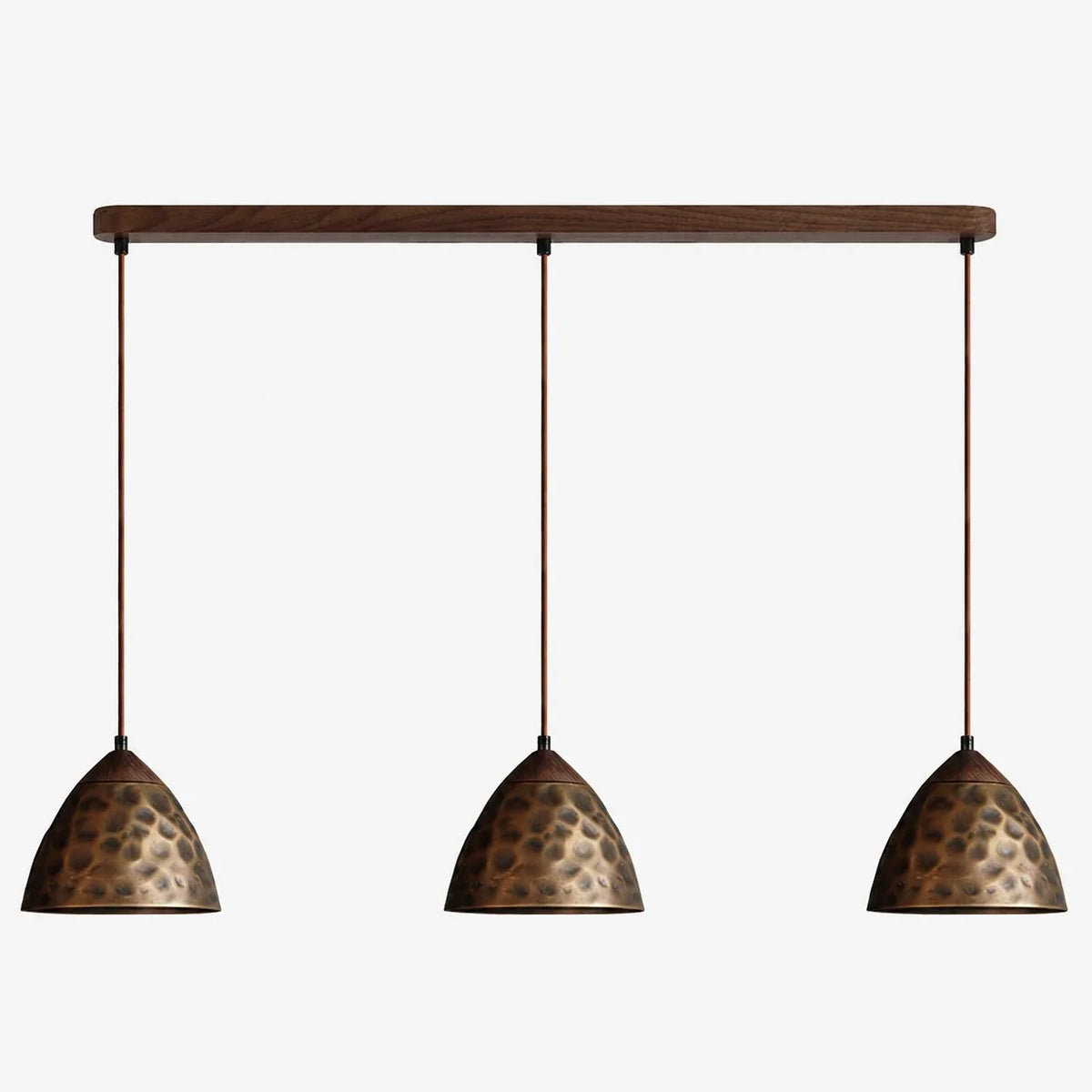 Three-light hammered copper hill pendant on walnut ceiling base