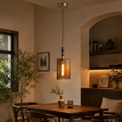 Amber glass pendant installed in a vintage dining room