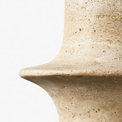 Close detail of polished travertine rim with natural pores and warm beige variation