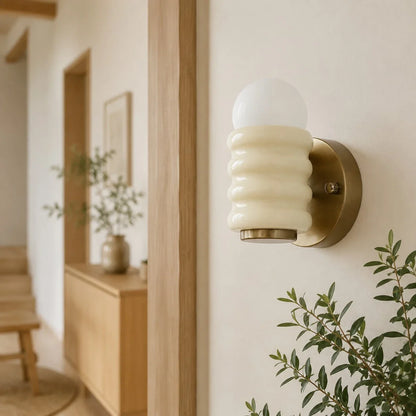 Cream wall sconce in hallway