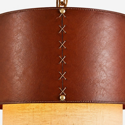Lower edge detail of brown leather drum pendant shade