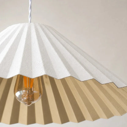 White pleated metal shade detail with gold interior