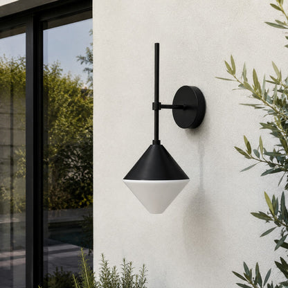 black and white outdoor wall sconce mounted on a garden exterior wall