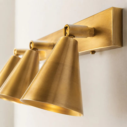 Angled detail of brass double cone wall light