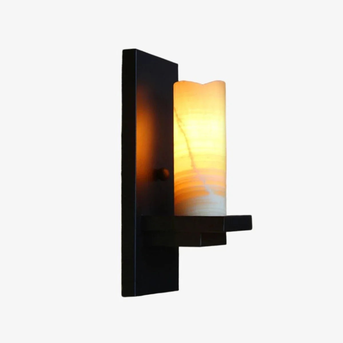 Black wall sconce with warm shade lit