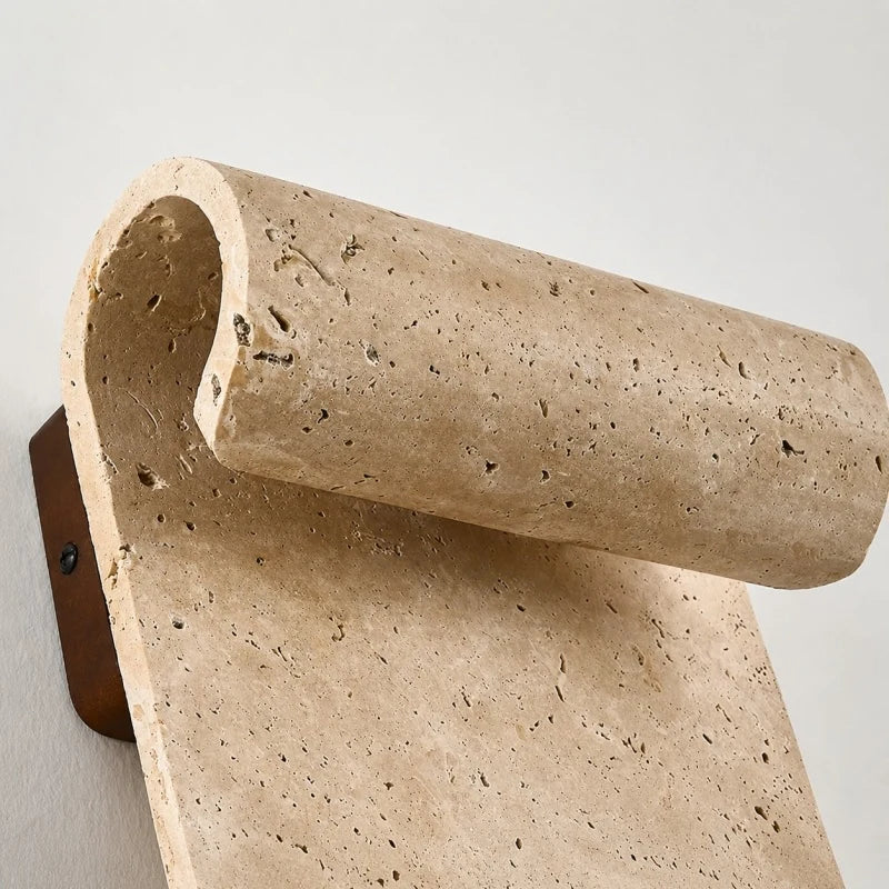 Side profile of natural travertine wall sconce