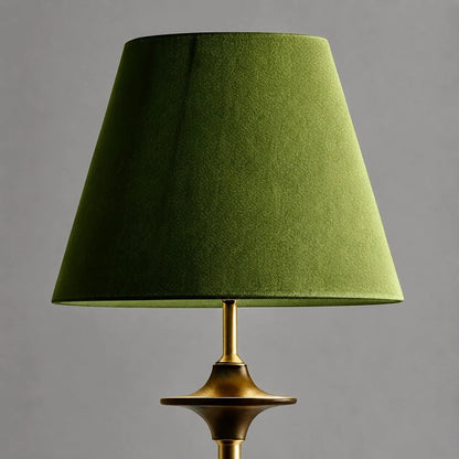 Close view of green fabric shade and brass tone stem