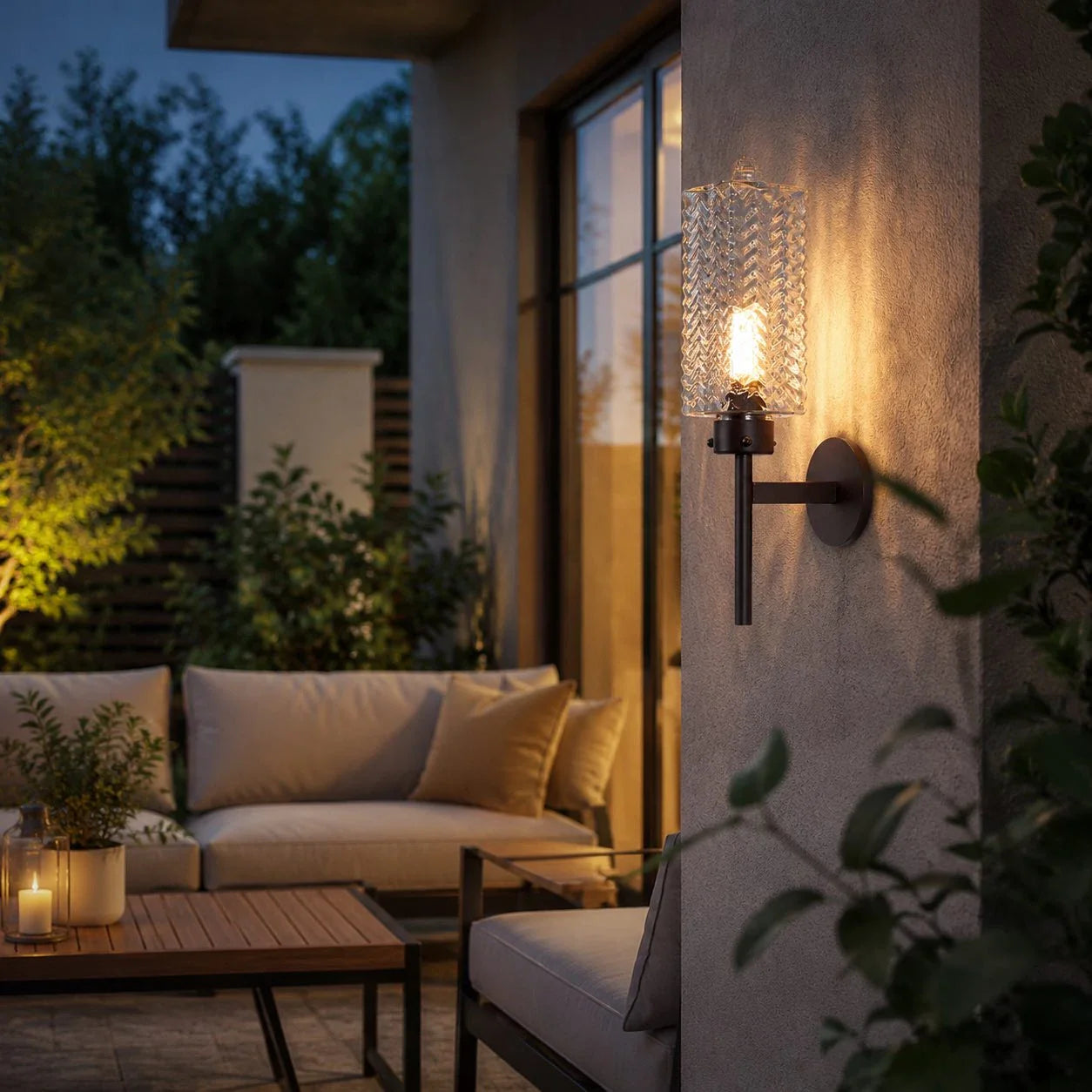 Outdoor wall sconce lit beside seating area