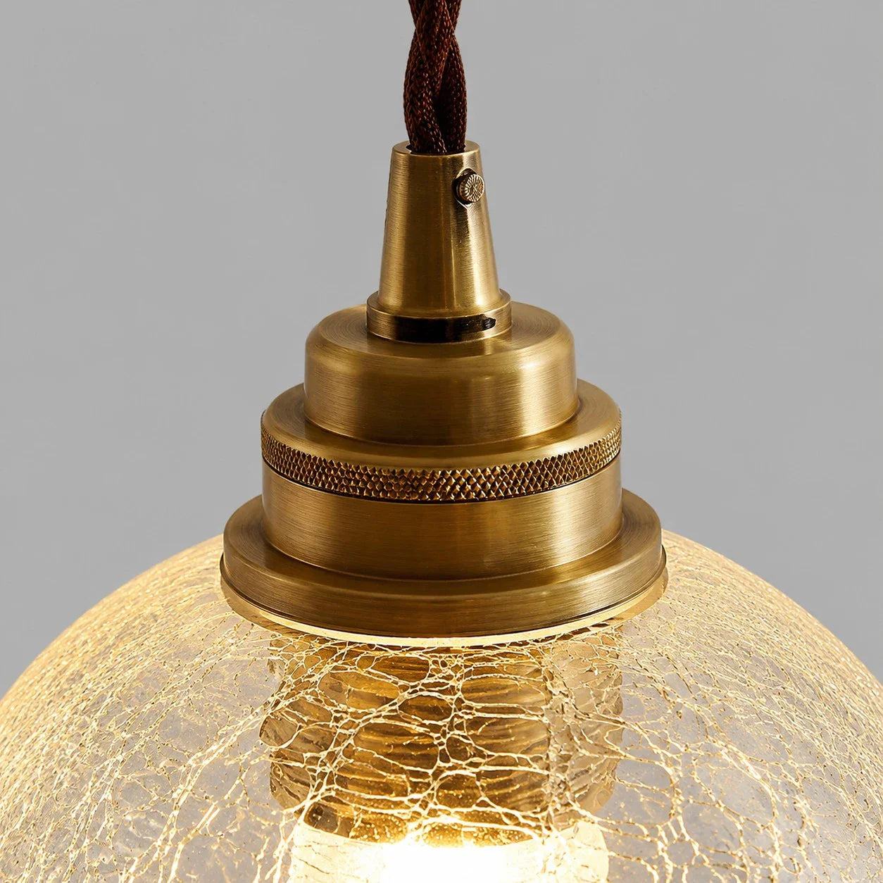 brass socket hardware and clear glass pendant shade detail