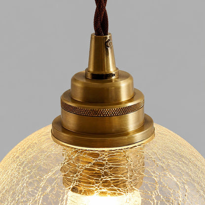 brass socket hardware and clear glass pendant shade detail