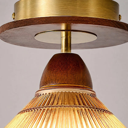 Brass tone canopy and wood tone ceiling light detail