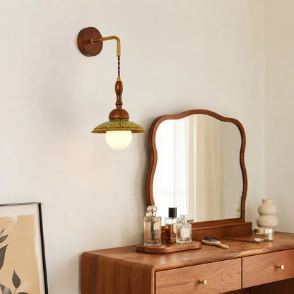 Wabi sabi wall light installed above a wooden dresser and mirror