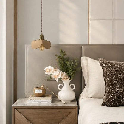 Leather petal pendant light above a bedroom nightstand