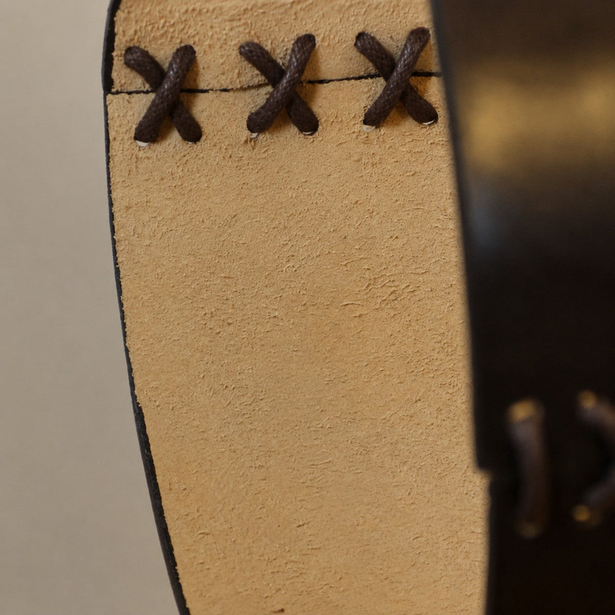 Leather pendant edge lacing close-up