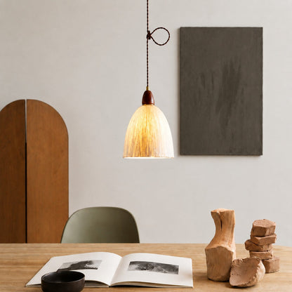 Tall rice paper pendant light over a table
