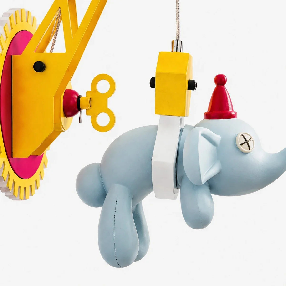 Close-up of blue elephant pendant and LED block