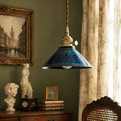 Blue glazed ceramic pendant light in a classic reading corner