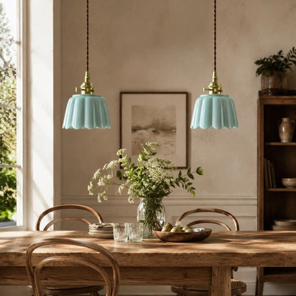 Pair of ceramic lotus pendant lights over a dining table