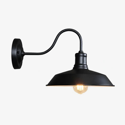 Black wall sconce with warm light on white background