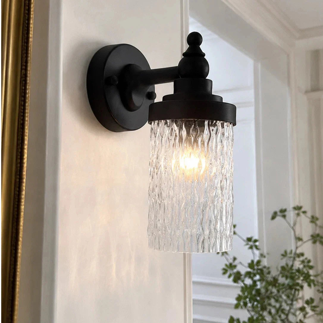 Averra ribbed glass outdoor wall sconce installed beside a covered porch wall