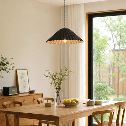 Black metal dome pendant lamp over a dining table