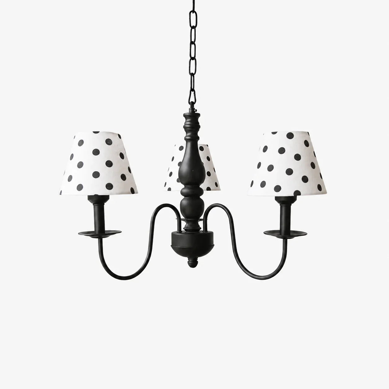 Three-light black chandelier with cream polka dot fabric shades