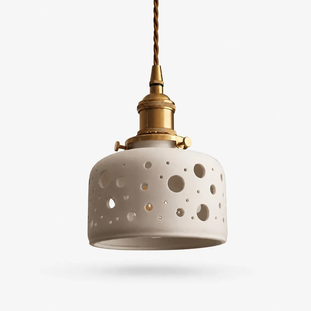 Round dot cutout ceramic pendant light with brass hardware