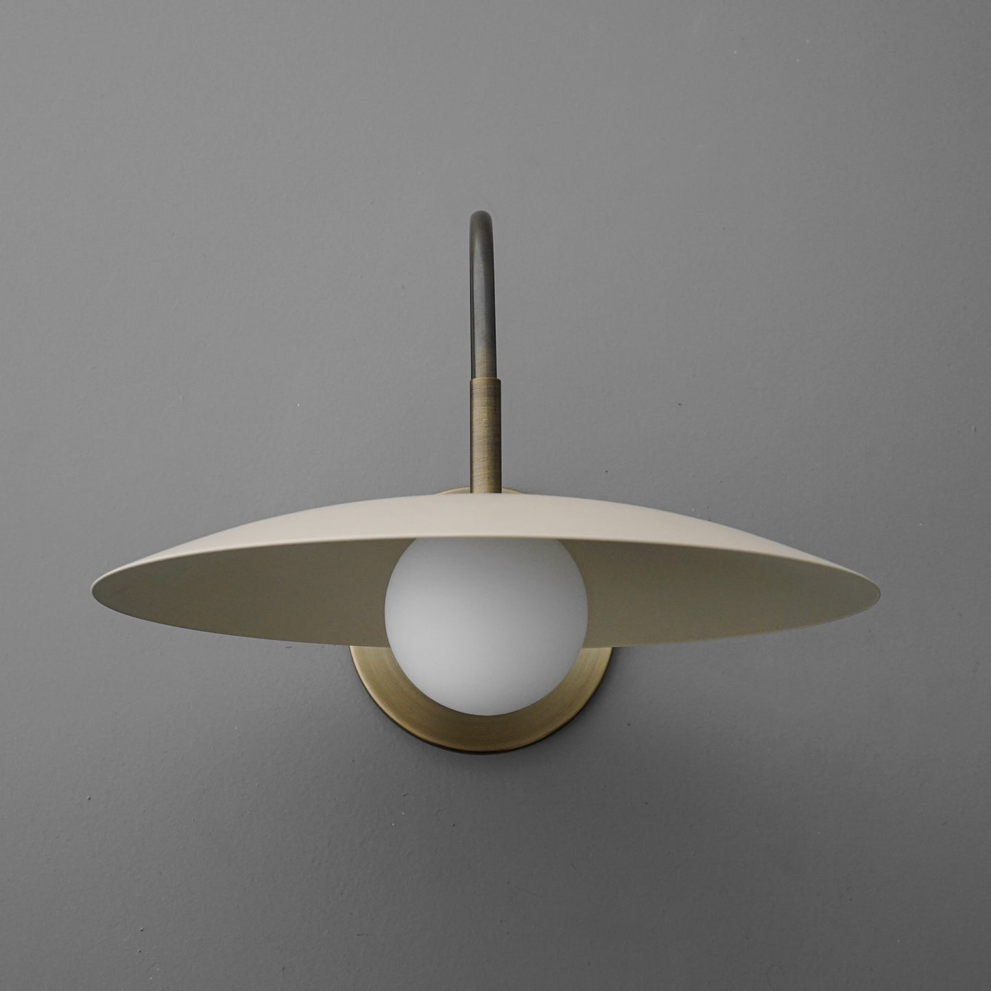 Curva Metal Modern Wall Sconce - Antique Brass Arm with Cream Disc Shade