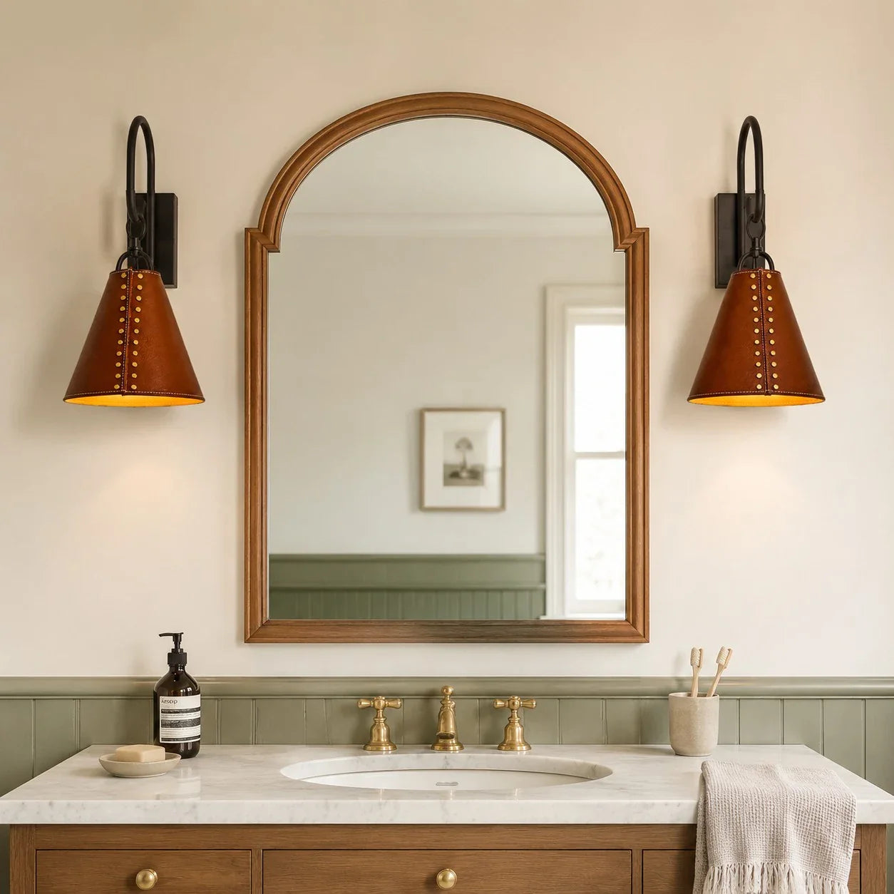 Pair of black and red leather wall sconces installed beside a bathroom mirror