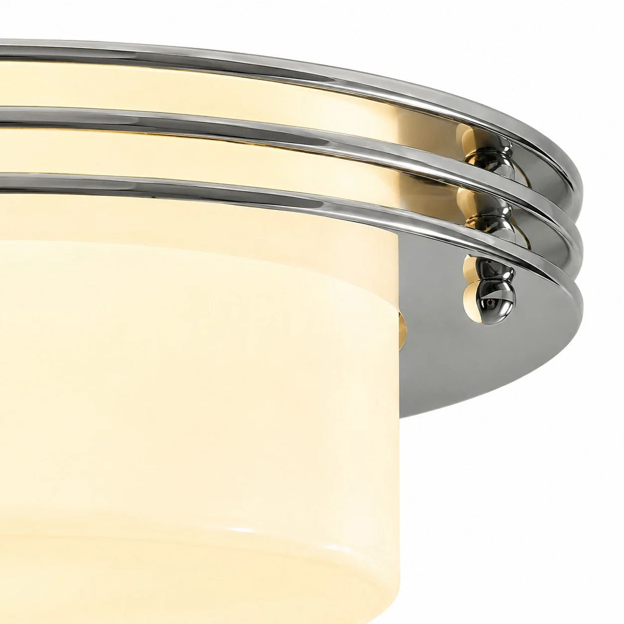 Low profile Bauhaus disc silhouette with chrome bands and milky white shade