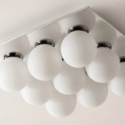 Detail image: frosted glass globes and chrome lamp holders.
