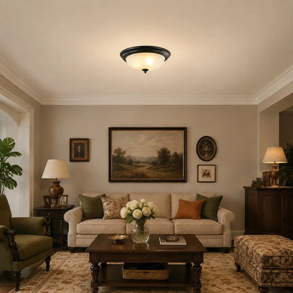 Vintage scrollwork ceiling light glowing in a living room