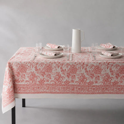 Soft coral floral tablecloth on a dining table