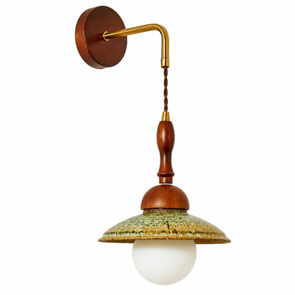 Side view of the Japanese wabi sabi wall sconce with round wooden backplate and brass wall arm